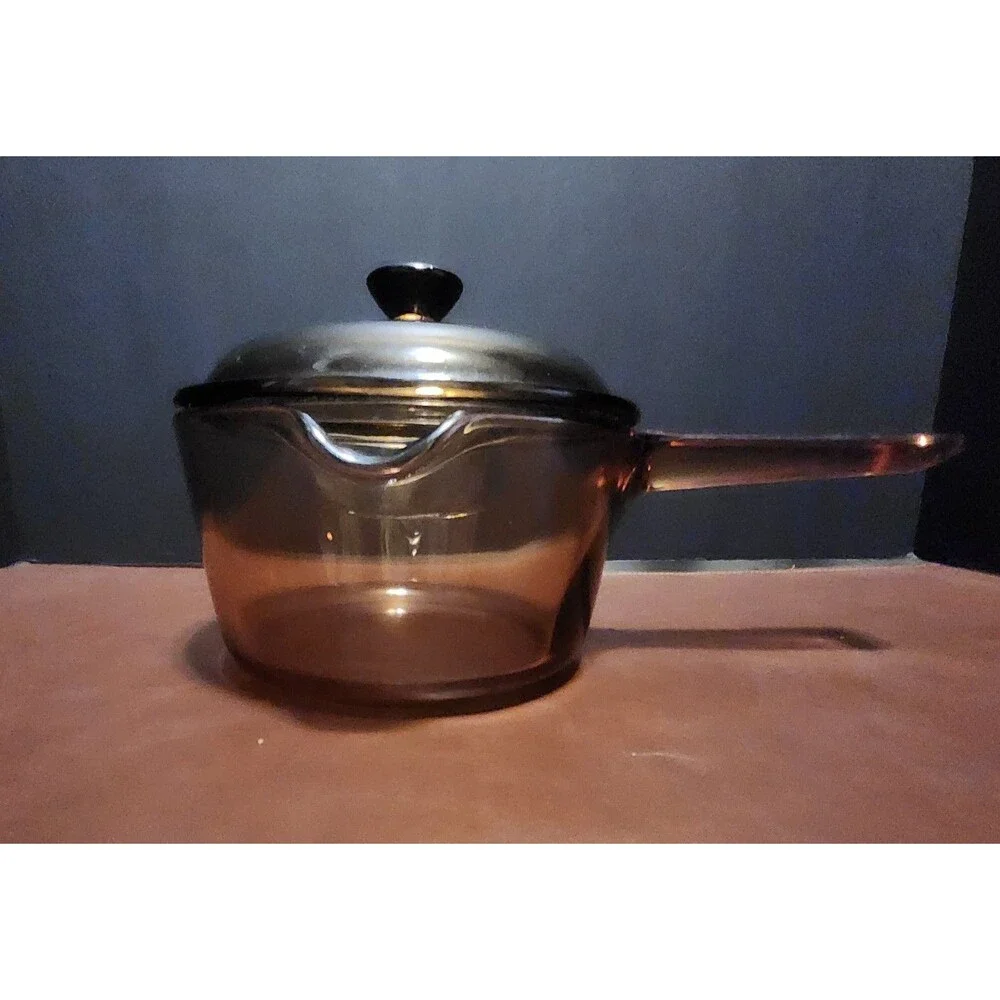 This item appears to be a vintage Corning Visions amber glass 1-liter...